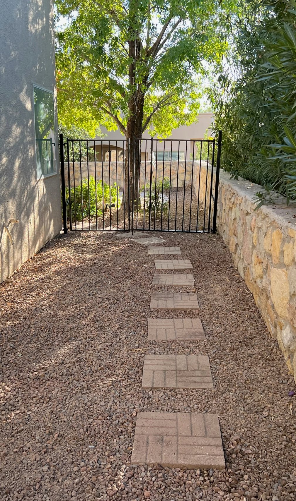 Paver walkway with stone retaining wall side yard by Brainard's Greenscapes