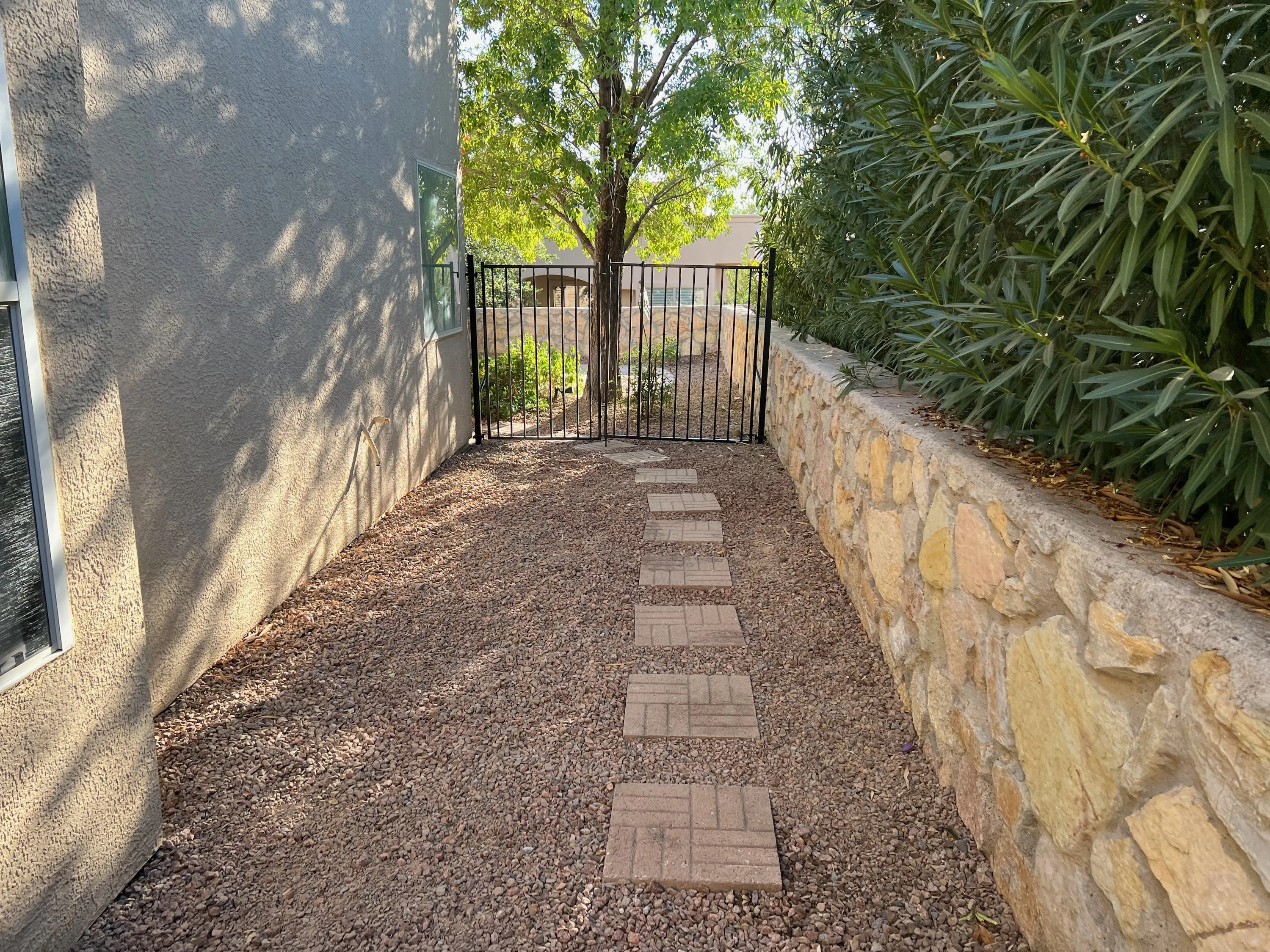 Paver walkway with stone retaining wall by Brainard's Greenscapes