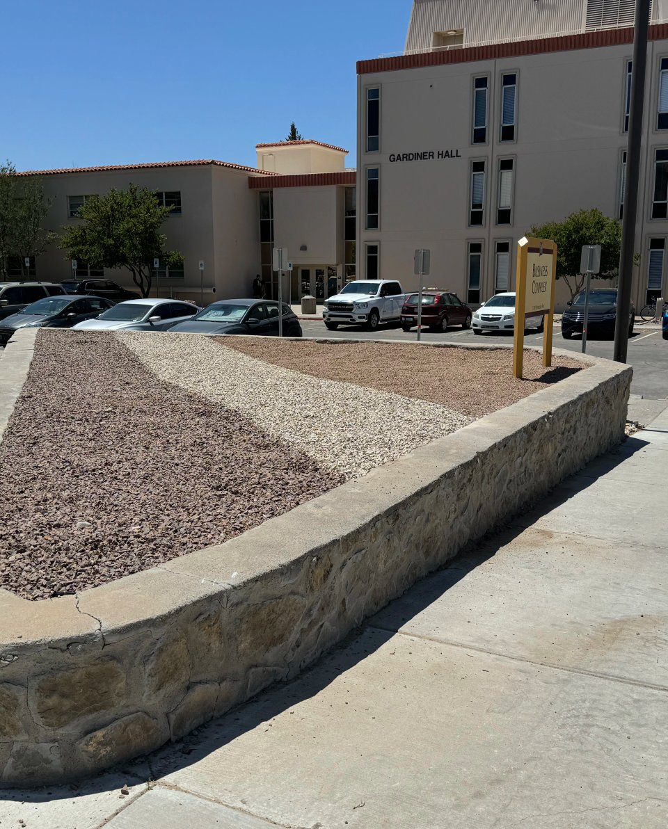 Decorative stone border edging a planting bed by Brainard's Greenscapes in Las Cruces