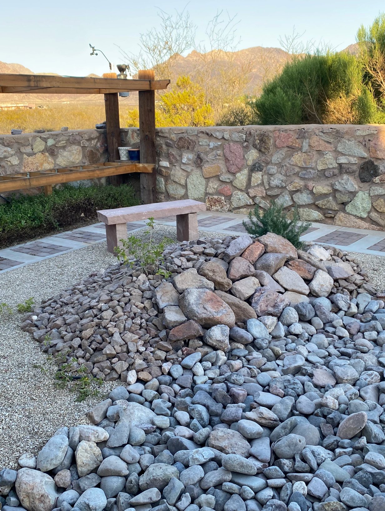 Brainard's Greenscapes landscaping installation with stone borders in Las Cruces