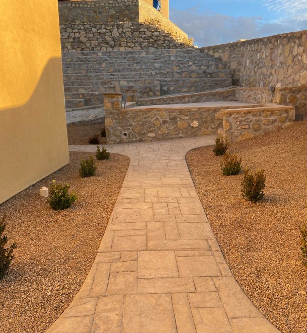 Stone walkway winding through a custom landscape